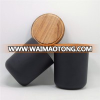 Matte black glass candle holder with smoked wood lid